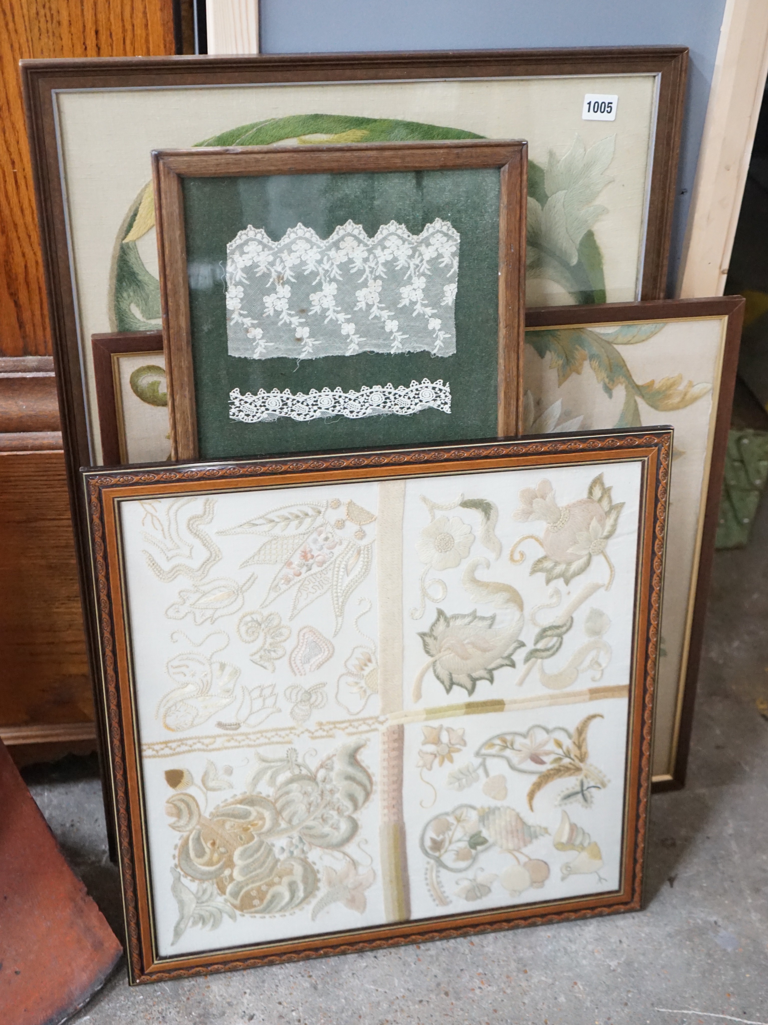 Eight framed embroideries / lace panels including a sampler